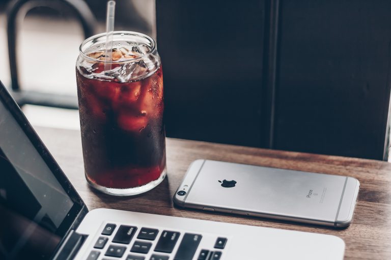cold brew beside laptop